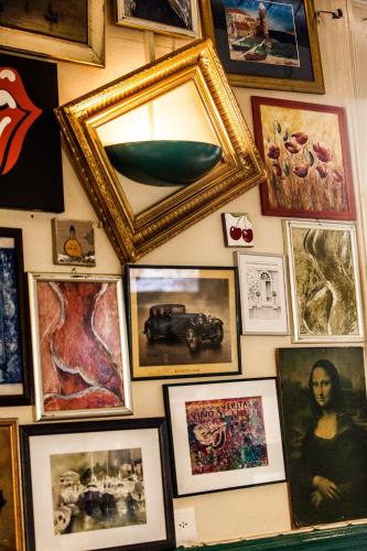a wall full of pictures on a wall at Happy Inn Lodge in Interlaken