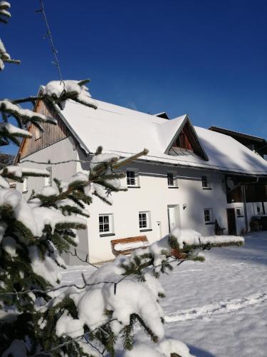 a white house with snow on the side of it at Ferienhaus Krallinger in Abtenau