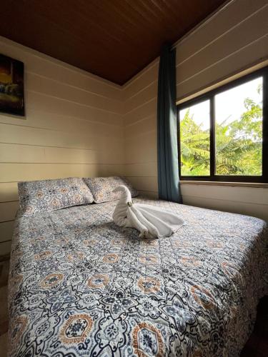 a bed in a room with a window at Bonanza in Monteverde Costa Rica