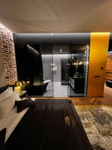 a room with a bed and a large mirror at Mandarin Club House in Batumi