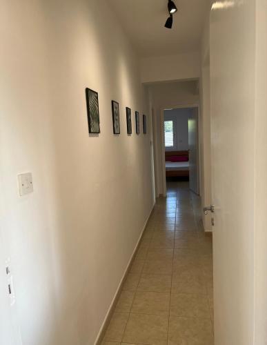 a hallway with white walls and a tile floor at Mountain View Apartment - Polis in Polis Chrysochous