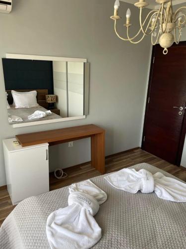 a bedroom with a bed and a large mirror at Deluxe Apartments Приморско in Primorsko