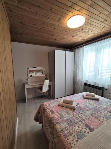 a bedroom with a bed and a desk with a computer at Villa Radić in Makarska