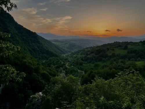 a view of a valley with trees and a sunset at Debatoun in Debed