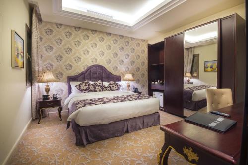 a hotel room with two beds and a desk at Mira Trio Hotel - Riyadh - Tahlia Street in Riyadh
