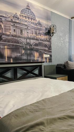 a bedroom with a picture of a building on the wall at Вілла Aqua Shayan in Shaian