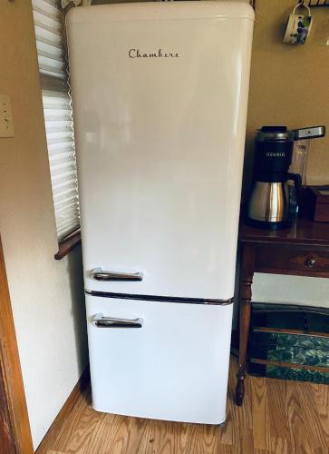 an old white refrigerator with the word chicago written on it at DunMovin’ Oregon in Grants Pass