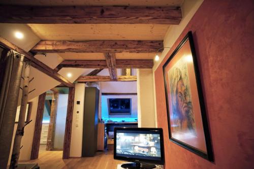 a living room with a tv and a painting on the wall at Ferienwohnung Ambiente in Gaggenau