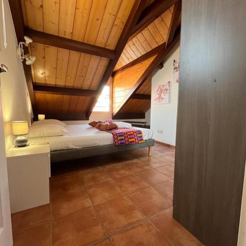 a bedroom with a bed with a wooden ceiling at La Rose du Marisol in Le Gosier