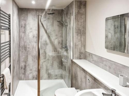 a bathroom with a shower and a sink at Berts Bothy in Threlkeld