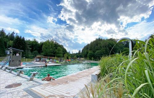 a swimming pool with people in the water at Ferienwohnung Ambiente in Gaggenau