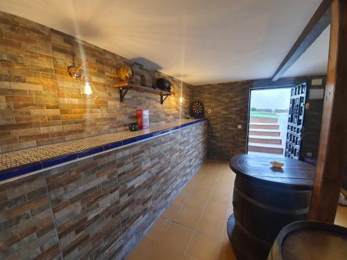a bar with a brick wall and a bar stool at Casa El Mirador 
