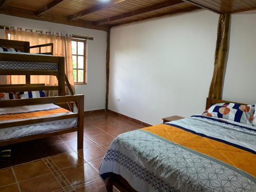 a bedroom with a bunk bed and a bunk bed at QUINTA VACACIONAL DIEGO ALFONSO, MY house in Macas in Macas
