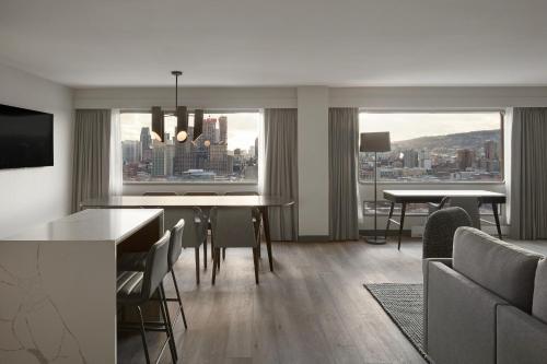 a dining room with a view of a city at Hyatt Place Montreal - Downtown in Montréal