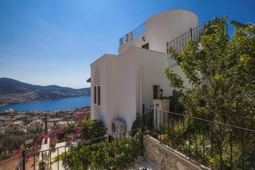 a white building with a view of the water at Villa Asya in Kalkan