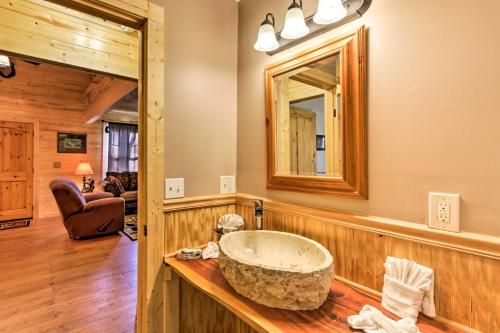 ein Badezimmer mit einem großen Steinwaschbecken auf einer Holztheke in der Unterkunft Just Fur Relaxin Sevierville Cabin with Hot Tub! in Sevierville