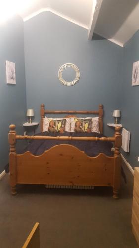 a bedroom with a wooden bed in a room at Atlantic cottage in Blackpool