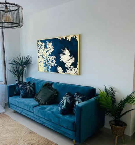 a blue couch with black pillows in a living room at Couples Only, beautiful 1 Bedroom Apartment in Victoria Building in Mojácar
