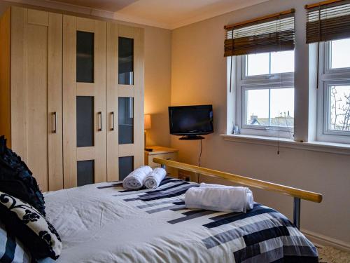 a bedroom with a bed with towels on it at Ocean View in Port William