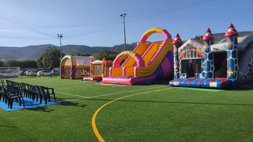 a group of playground equipment on a grass field at Mattinata Camping in Mattinata