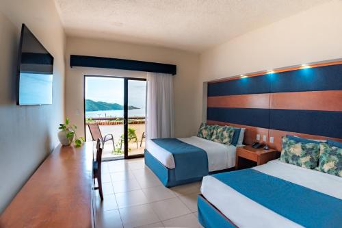 a hotel room with two beds and a balcony at Villas Sol Beach Resort - All Inclusive in Playa Hermosa