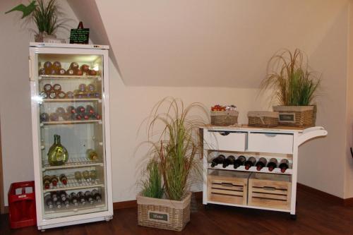 a room with a wine cellar with plants at Dünen Stuuv in Sankt Peter-Ording