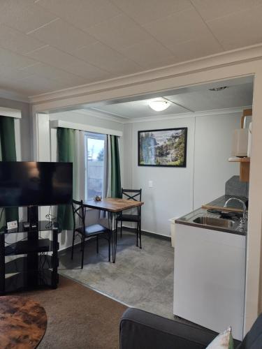 a living room with a kitchen and a dining room table at Inn at Arch Rock in Depoe Bay