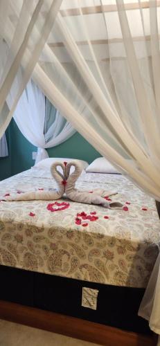 a bed with two swans made out of towels at Pipa Blue in Pipa