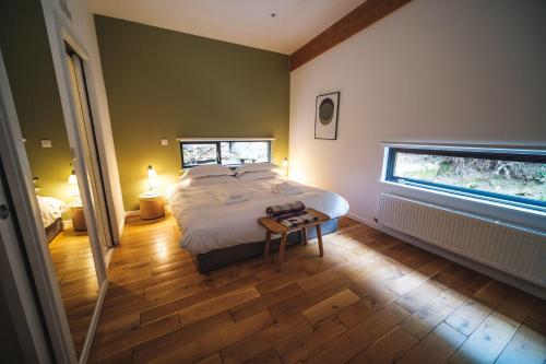 a bedroom with a large bed and a window at Yorkshire Dales Lodge 15 by Together Travel - 3-Bed Premium Ensuite in Richmond