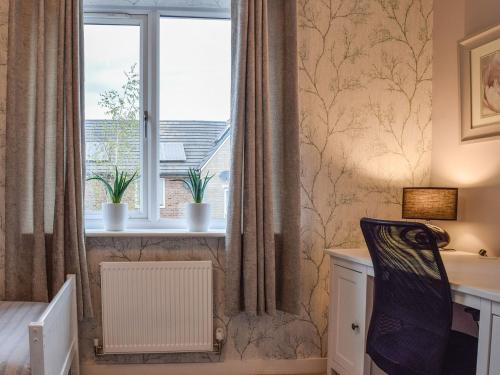 a bedroom with a window and a desk and a window with curtains at Eddleston Cottage - Reading in Reading
