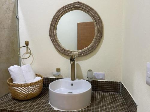 a bathroom with a white sink and a mirror at Studio 27 Colonial, Centro Histórico in Santo Domingo