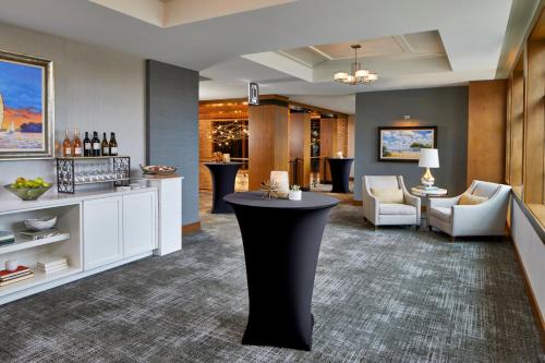 a lobby with a bar in the middle of a room at The Hotel Landing in Wayzata