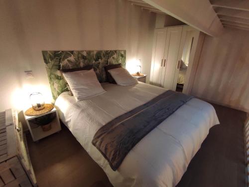 a bedroom with a large bed with white sheets and pillows at Chill Out Cabanon Coeur Calanques in Marseille