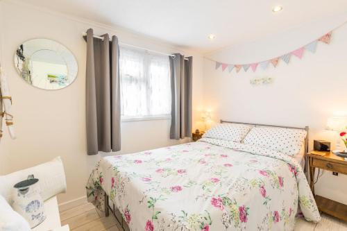 a bedroom with a bed and a window at The Happy Hedgehog in Mundesley