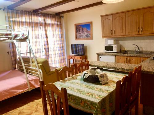 eine Küche mit einem Tisch und einem Etagenbett in der Unterkunft VV APARTAMENTOS ESTRELLA DEL NORTE in Icod de los Vinos