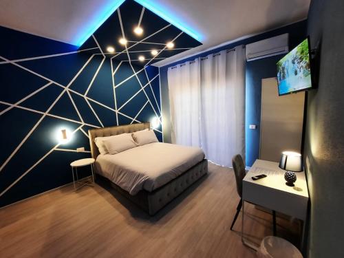 a bedroom with a bed and a tv on a wall at U Baruni B&B in Messina