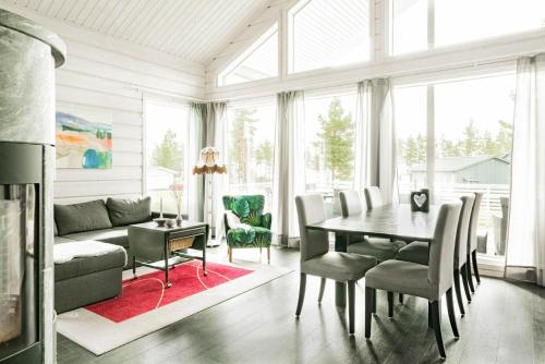 a living room with a table and chairs and a couch at Beautiful house with sea view in Piteå