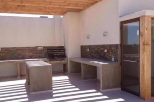 a room with tables and benches in a building at ARRIENDO EXCLUSIVO DPTO en LA SERENA in La Serena