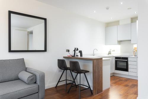 a living room with a couch and a kitchen at Fernbank in Dublin