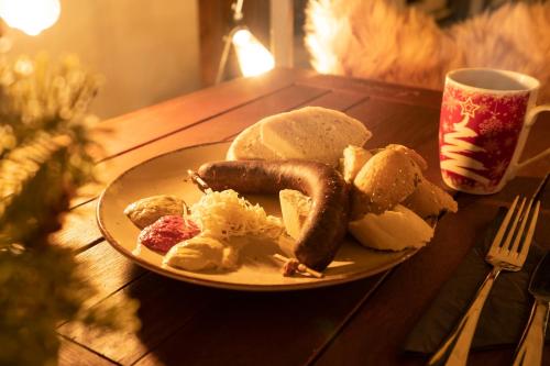 a plate with sausage and other food on a table at Penzion Panská in České Budějovice