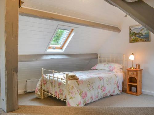 a bedroom with a bed in a attic at Monkwood Cottage in Hale