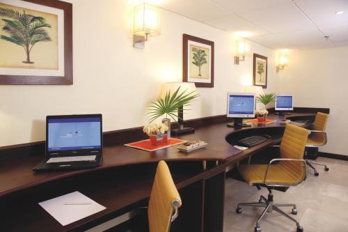 an office with a desk with a laptop computer on it at Dar es Salaam Serena Hotel in Dar es Salaam