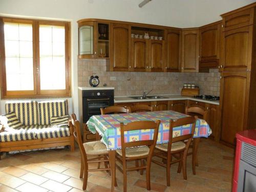 a kitchen with a table and chairs and a couch at Su Suergiu in San Giovanni Suèrgiu