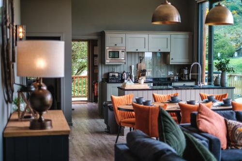 a kitchen and living room with a table and chairs at Yorkshire Dales Lodge 10 by Together Travel - 3-Bed Ensuite Retreat in Richmond