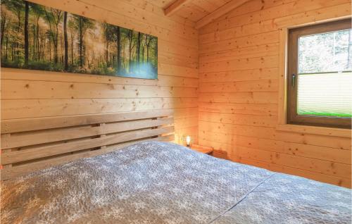 a bedroom with a bed in a log cabin at Beautiful Home In Merzalben With Kitchen in Merzalben