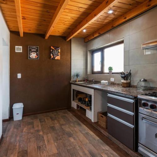 a kitchen with a sink and a counter top at PEWMA Casa de Montaña in Caviahue
