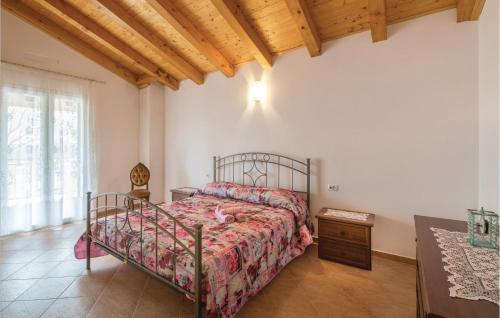a bedroom with a bed and a wooden ceiling at Stunning Home In Nedescina With Outdoor Swimming Pool in Nedeščina