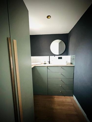 une salle de bain avec un lavabo et un miroir dans l'établissement La vie en Grange, la Loire et les châteaux, à Dhuizon