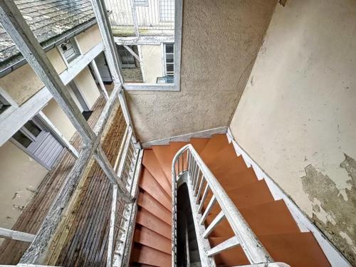 an overhead view of a staircase in an abandoned building at Résidence Bury in Tulle