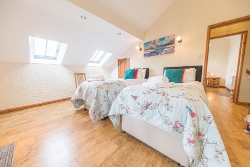 a bedroom with two beds and a window at The Stables, Knotts Farm Windermere in Windermere